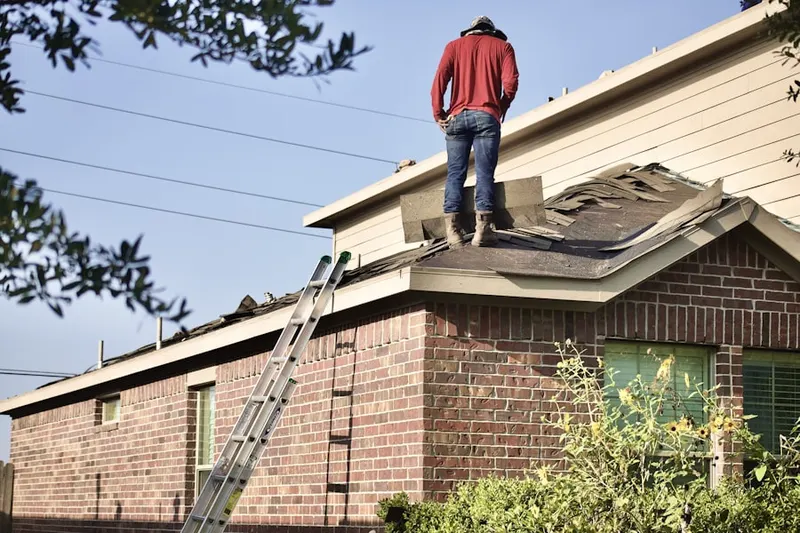 Professional roofer working on a residential roof in Chase